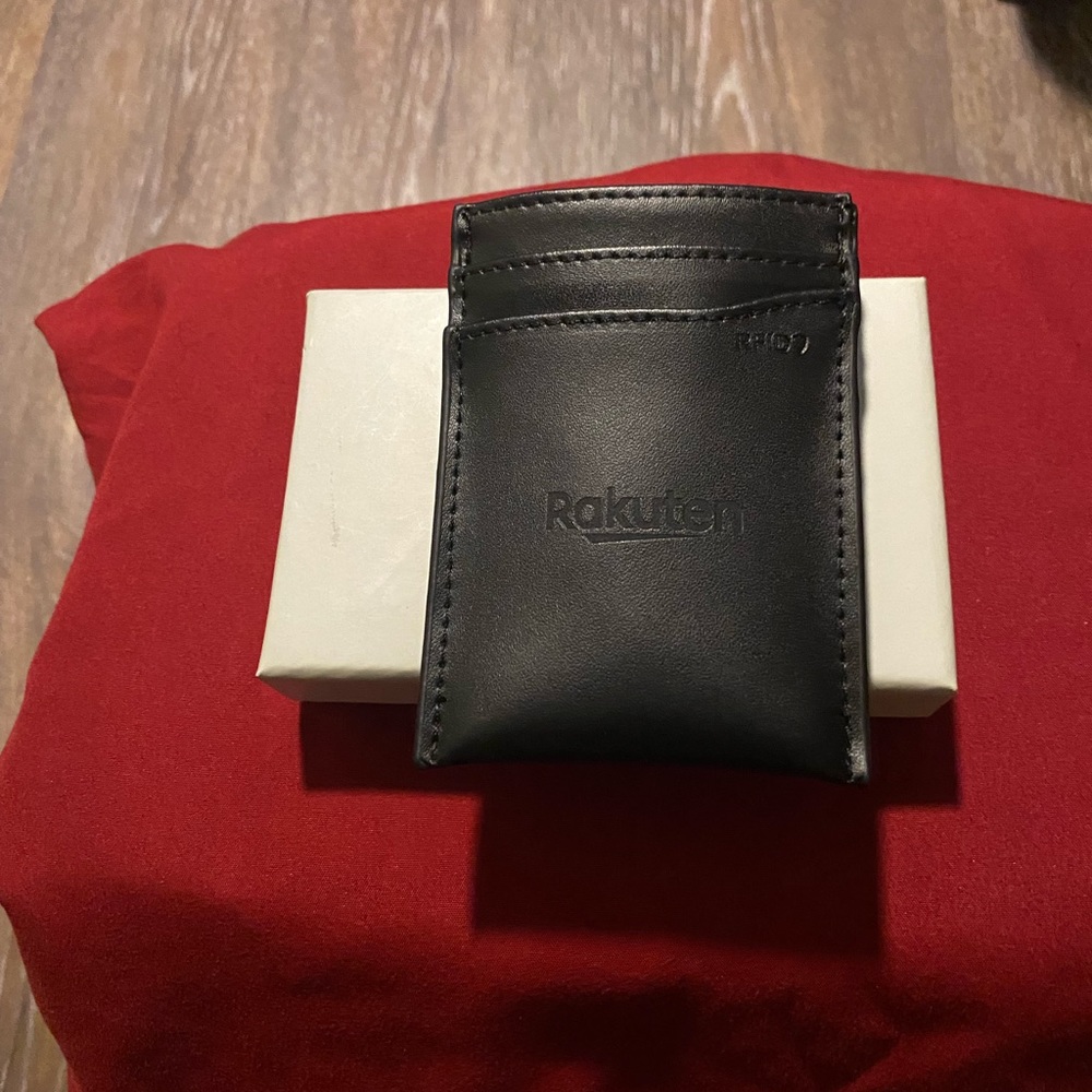 Man’s black leather money clip & card holder.